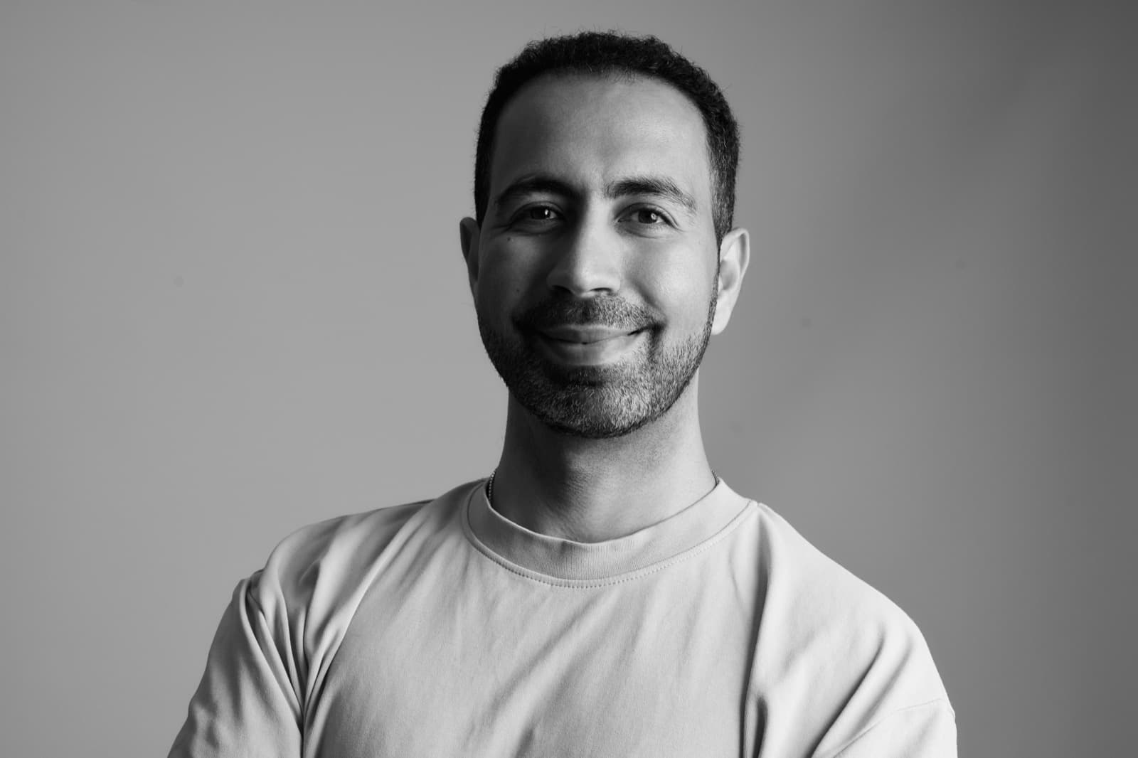 Farhad Malegam, founder of Dream Websites, smiling with arms crossed