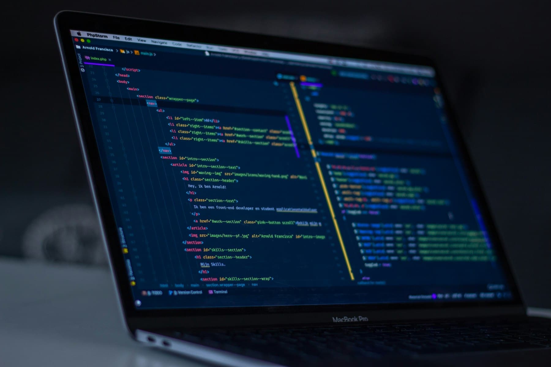 Code open on a MacBook in a dark workspace